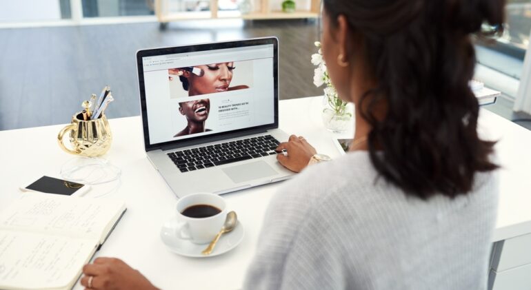 Laptop,,Coffee,And,Woman,With,Notebook,In,Office,Reading,Information